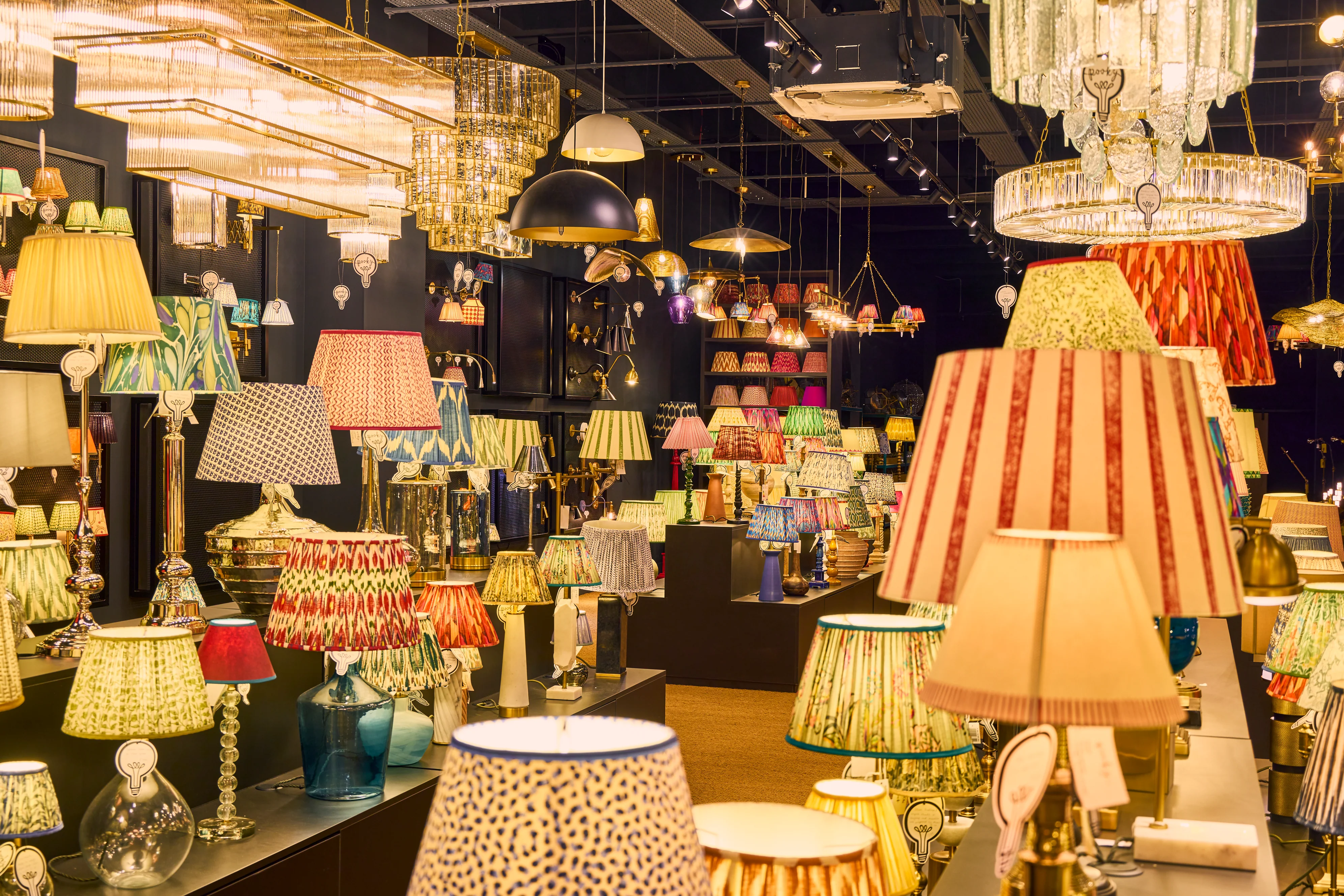 Elegant interior illuminated by decorative pendant lights and contemporary chandeliers