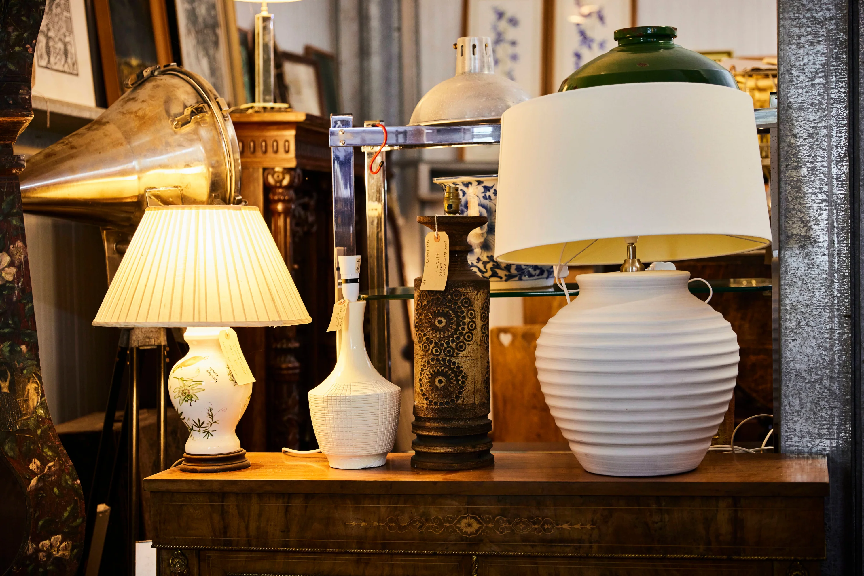 Carefully arranged decorative lamps and chandelier designs in a lighting showroom